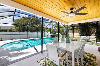 View of swimming pool with a patio area, glass enclosure, and ceiling fan