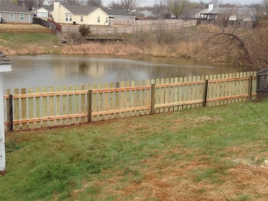 Fenced backyard with a water view and a residential view