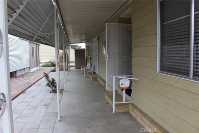 East side patio as seen from the front walkway, with the front door and slider on the right.