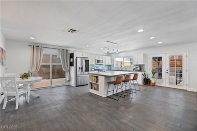 Kitchen featuring white cabinets, a center island,