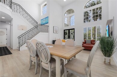 Dining space with a towering ceiling and light har
