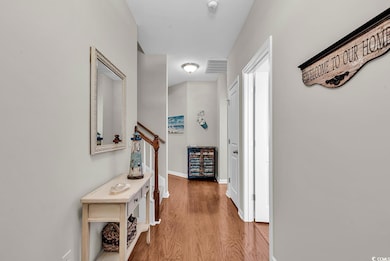 Hallway featuring light wood-style floors, visible