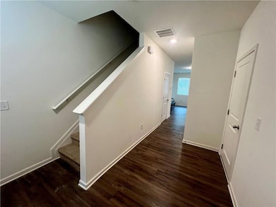 Staircase with wood finished floors and baseboards
