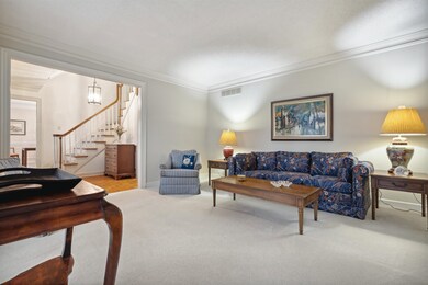 Living room with carpet floors, an inviting chande