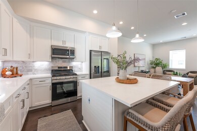 Modern kitchen with sleek cabinetry, stainless ste