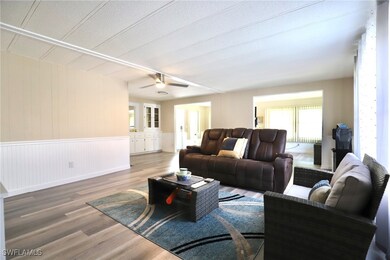 Living room with a textured ceiling, wood-type flo