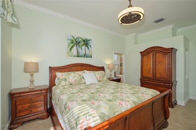 Bedroom featuring crown molding and baseboards