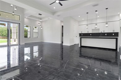 Unfurnished living room featuring ceiling fan, dar