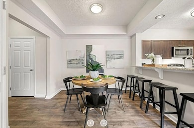 Dining room with dark hardwood / wood-style floors