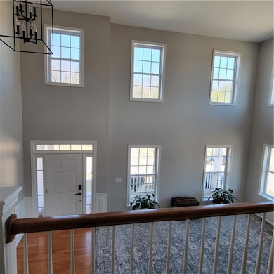 2 story Entryway featuring hardwood / wood-style f