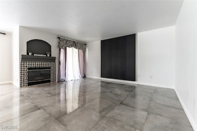 Unfurnished living room featuring baseboards and a
