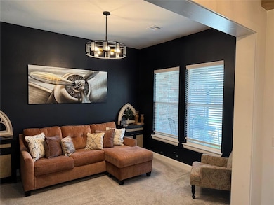 Flex room featuring carpet floors, a chandelier, healthy amount of natural light, and baseboards