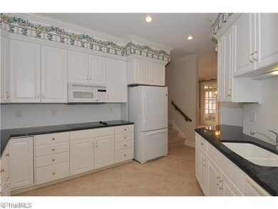 Kitchen. Walk right in from the garage/mud room with those groceries! Solid surface counters, double ovens and lots of cupboards and counterspace create a wonderful kitchen; the flooring is recent and the refrigerator remains