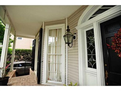 Photo. Lovely front porch with gas lights.