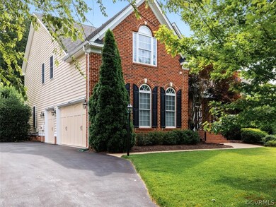 View of the paved driveway leading to a true 3 car