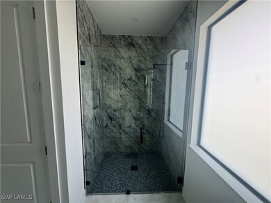 Full bathroom with a marble finish shower