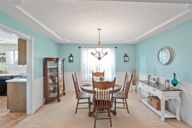 Separate dining room with coffered ceiling and cha