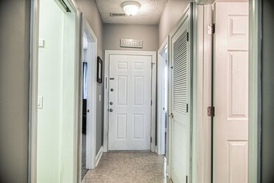 Corridor featuring light tile patterned flooring a