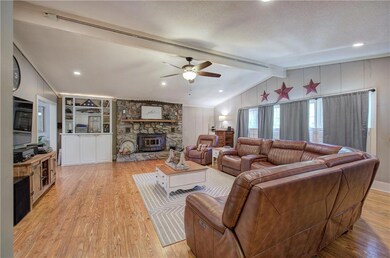 Living room with built in shelves, vaulted ceiling