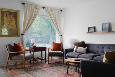 Sitting room with wood finished floors and basebo