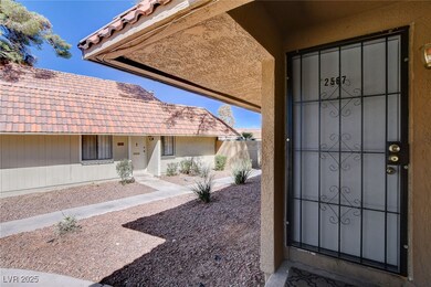 View of exterior entry with a tiled roof and stucc