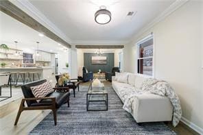 Living area with crown molding and dark wood-type flooring