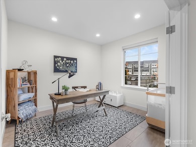 Office/Den with french doors grace the front entry.
