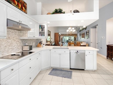 Kitchen with kitchen peninsula, dishwasher, backsp