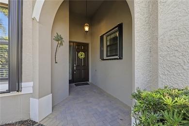 Property entrance with stucco siding and a porch