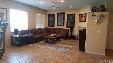 Warm family room with fireplace, ceioling fans and