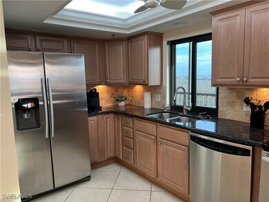 Kitchen featuring sink, a tray ceiling, stainless
