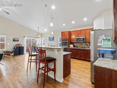 Kitchen featuring a ceiling fan, a breakfast bar a