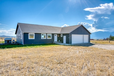 Single story home featuring a mountain view, driveway, a garage, and a shingled roof