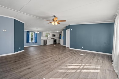 Unfurnished living room with crown molding, ceilin