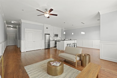 Living area opens to modern kitchen with stainless
