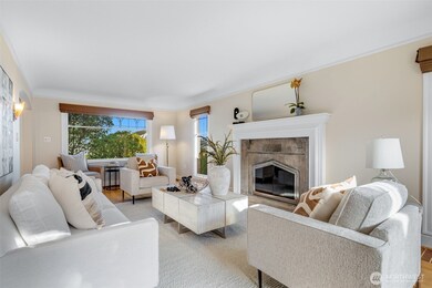 Both ends of the living room have large windows for great natural light at all times of the day.  The front windows face the city, and are a perfect place to sip your morning coffee with a  view of the space needle. Notice the original leaded glass tulip windows- these grace both the living and dining rooms.