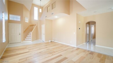 Entryway featuring arched walkways, wood finished