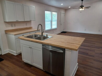 Kitchen with stainless steel dishwasher, a sink, 