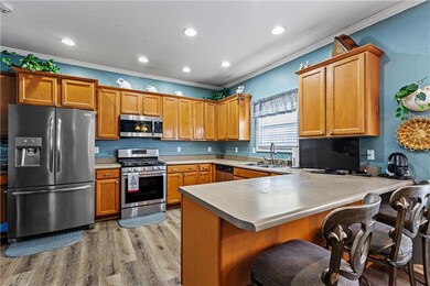 Kitchen with crown molding, light wood-style floor