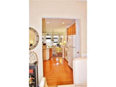 The dining room leads into the kitchen and living areas. Look at those hardwoods!