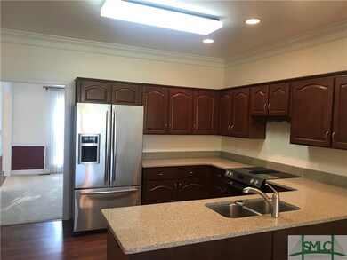 View from breakfast nook into kitchen with view into formal dining room