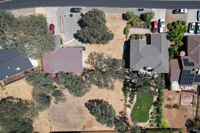 An aerial view of the vacant lot for sale. The cur
