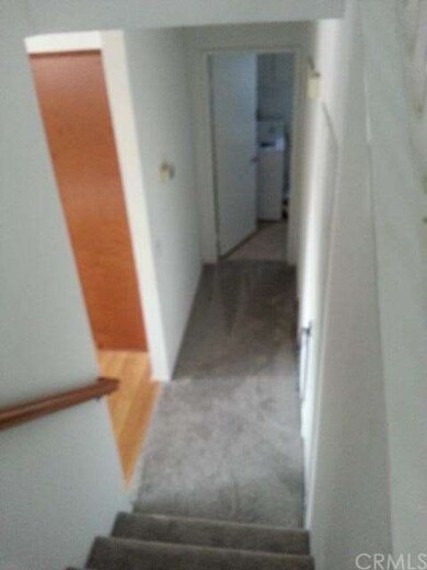 looking down stairs towards laundry kitchen wood f