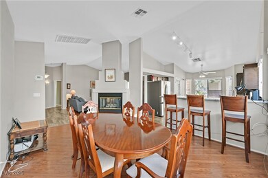 Dining area featuring vaulted ceiling, light wood-