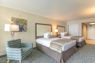 Tiled bedroom featuring a closet, a textured ceili