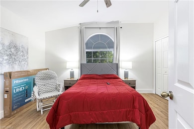Bedroom with hardwood / wood-style flooring, a clo