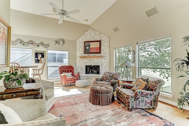 Pretty living room w/pretty stone fireplace! Light & bright room w/hard surface flooring. Windows to the right overlook the gold course and pond!