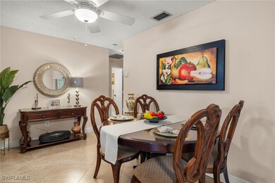 Tiled dining space with ceiling fan and a textured