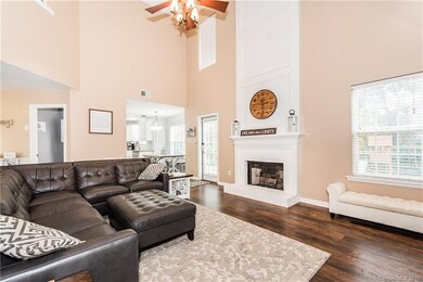 View from great room into the large chef's kitchen as well as the access door to the private, fenced backyard with custom patio and fire pit!