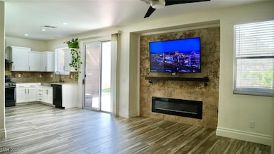 Unfurnished living room with ceiling fan, light wo